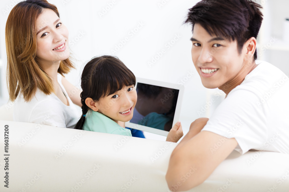 happy family and daughter watching tablet on sofa happy family and daughter watching tablet on sofa