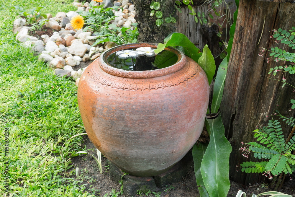 big earthen jar with grunge in the garden big earthen jar with grunge in the garden