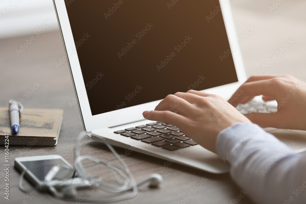 Woman's hands using laptop at the table Woman's hands using laptop at the table