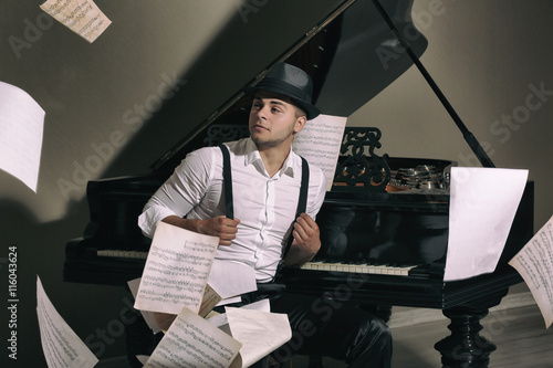 Handsome musician with piano