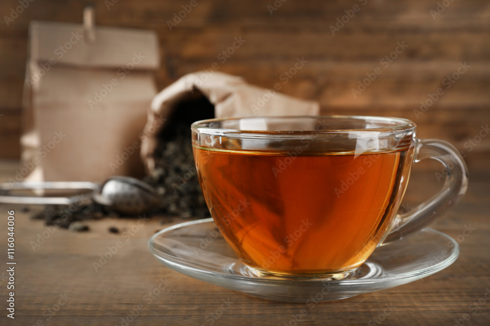 Cup of black tea on wooden table Cup of black tea on wooden table