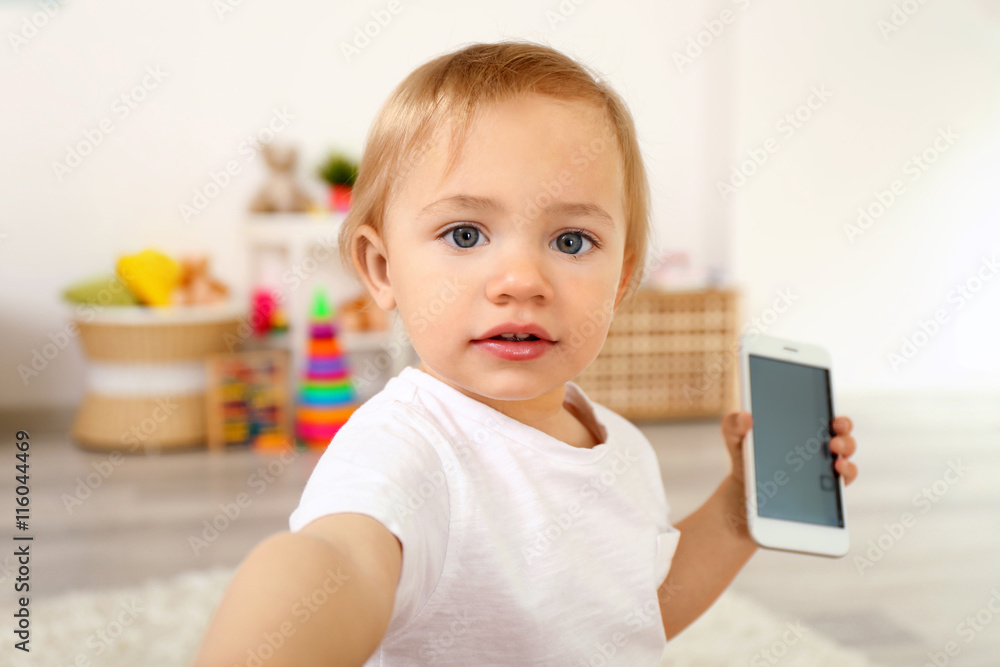 Cute baby girl playing with a smartphone Cute baby girl playing with a smartphone