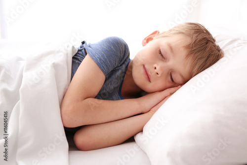 Adorable little boy sleepin...