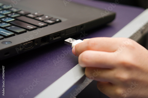 USB stick or USB thumb drive with virus plug in to laptop comput