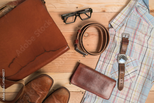 Clothing and accessories for men on wood background