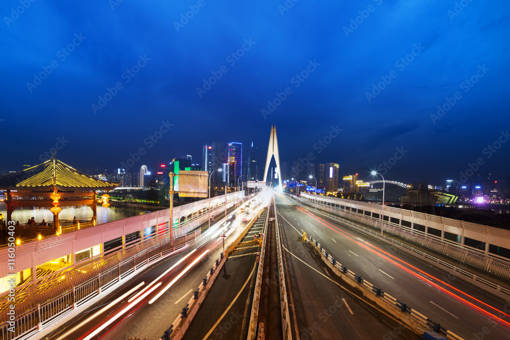 Fototapeta premium busy traffic on bridge near downtown of chongqing at twilight