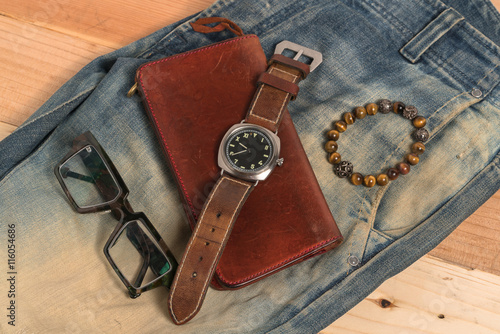 Jeans Wallet and Belt watches glasses on wood background 