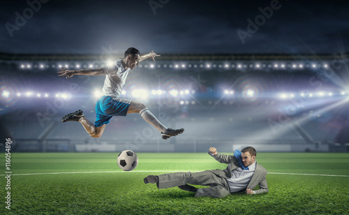 Businessman and player fighting for ball . Mixed media