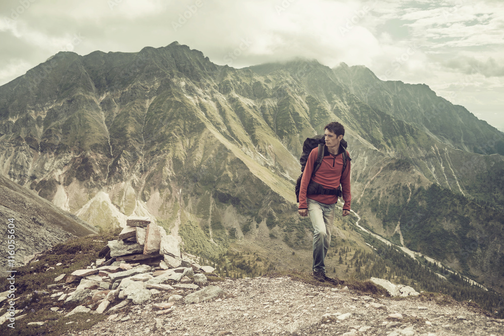 Fototapeta premium man climbs a mountain at the beautiful view