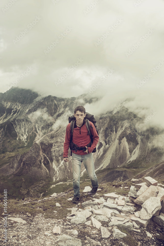 Fototapeta premium man climbs a mountain at the beautiful view