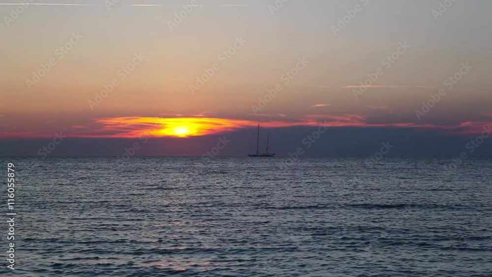 Lonely boat at sea and dramatic sunset on the empty beach, Rhode Island, USA Lonely boat at sea and dramatic sunset on the empty beach, Rhode Island, USA