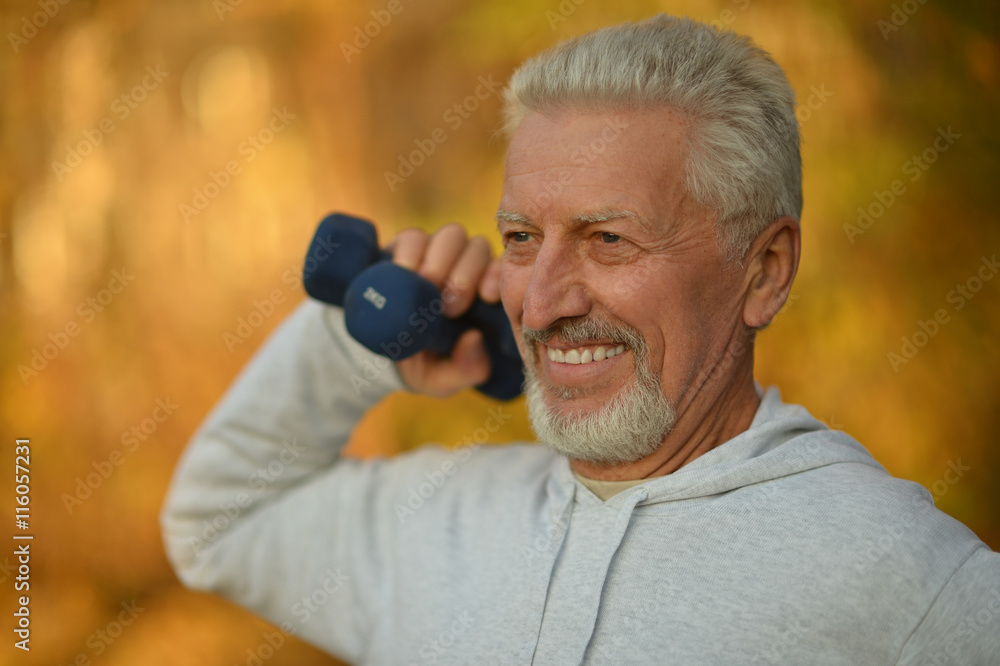 Elderly man exercising with dumbbells Elderly man exercising with dumbbells