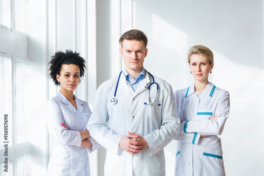 Attractive male doctor in front of his medical team Attractive male doctor in front of his medical team
