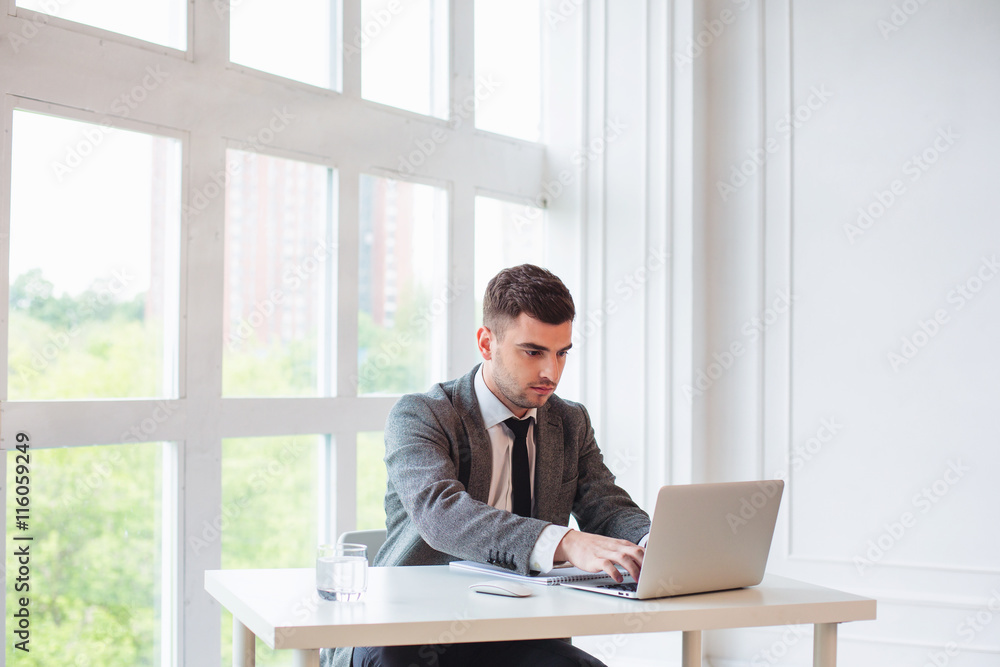 Handsome businessman is working in a office Handsome businessman is working in a office