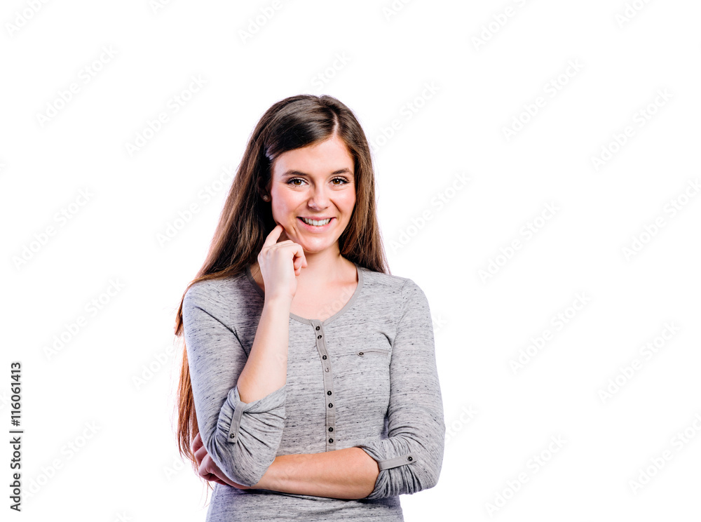 Girl in gray longsleved t-shirt young woman, studio shot Girl in gray longsleved t-shirt young woman, studio shot