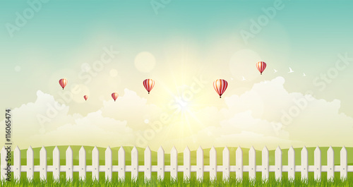 Fantasy Vector Landscape Background, Sunset and hot air ballons on cloudy sky and grass field with wooden fance.
