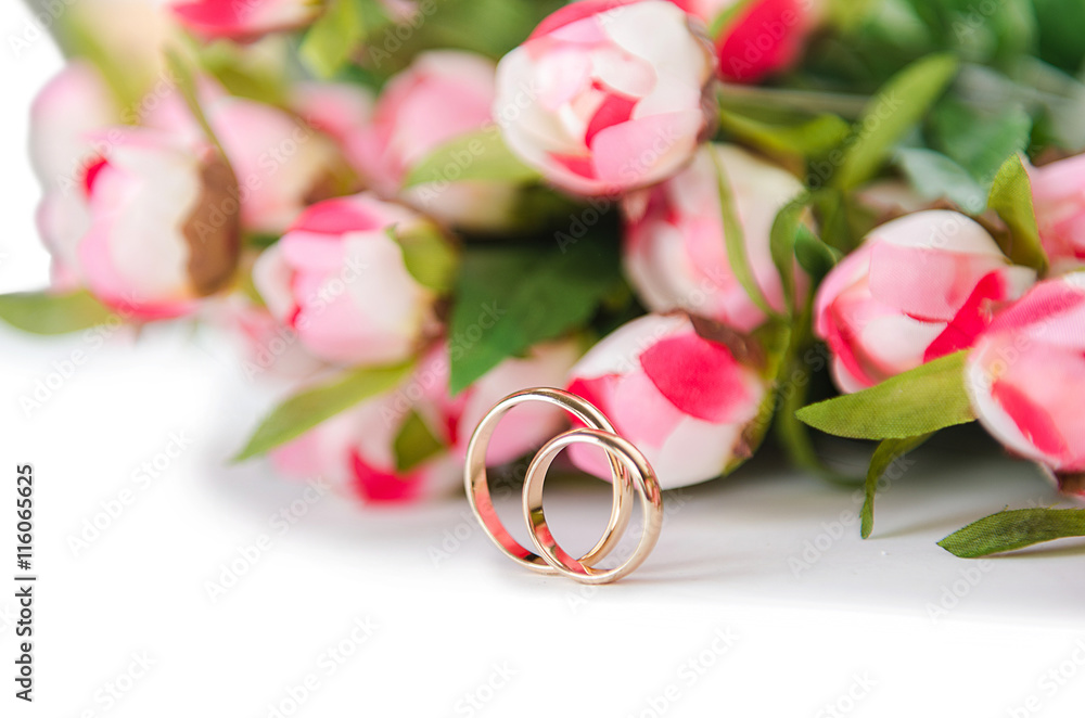 Wedding rings and flowers isolated on white background Wedding rings and flowers isolated on white background