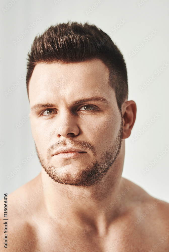 Closeup portrait of a young handsome guy, isolated on white, side-view Closeup portrait of a young handsome guy, isolated on white, side-view