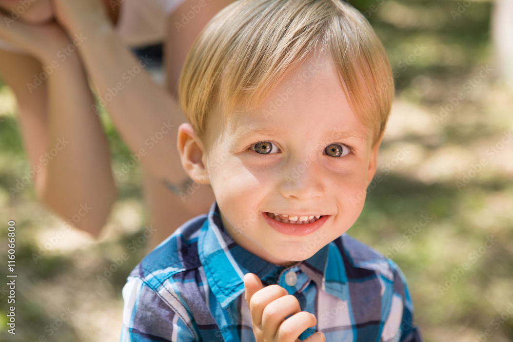 Portrait of blonde little boy posing outside
Portrait of blonde little boy posing outside