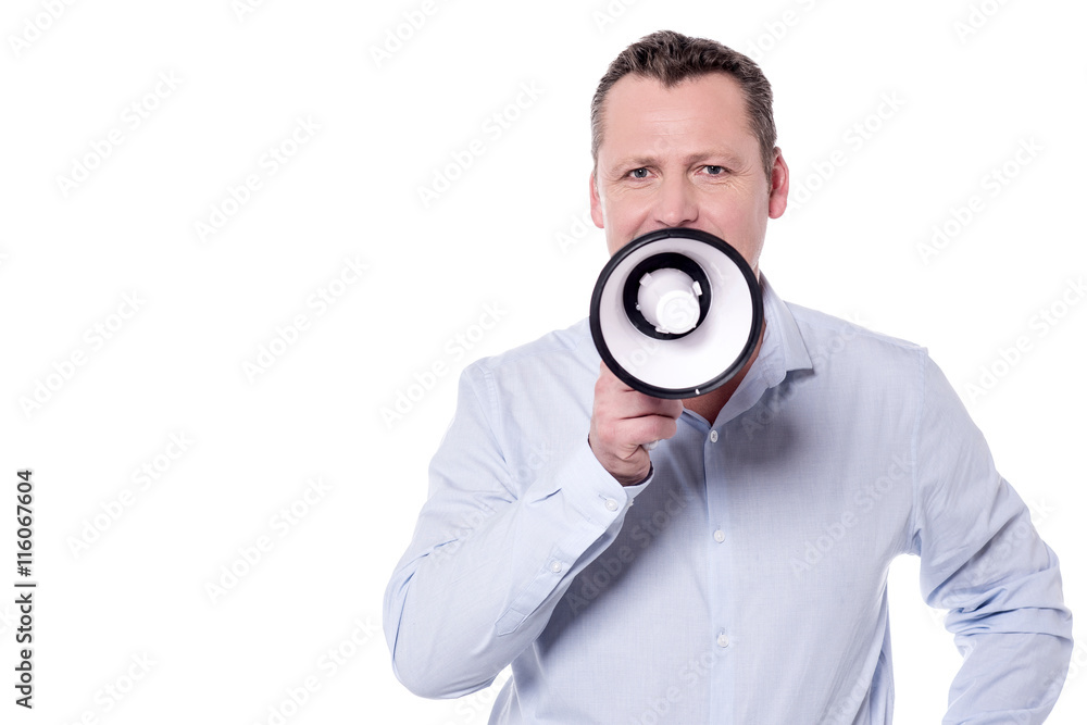 Casual man making advertisement in megaphone Casual man making advertisement in megaphone