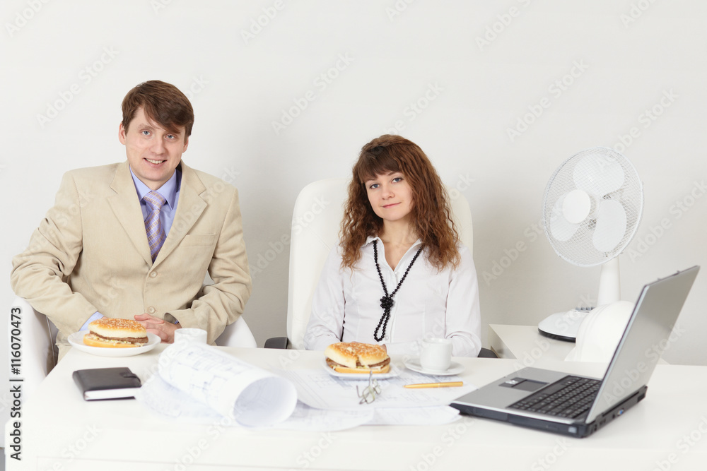 Business people - man and woman meet for dinner at workplace in Business people - man and woman meet for dinner at workplace in