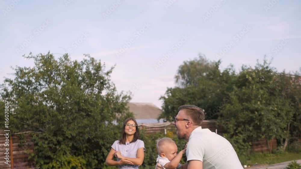 Happy Dad Having Fun With His Little Smiling Son In The Garden Happy Dad Having Fun With His Little Smiling Son In The Garden