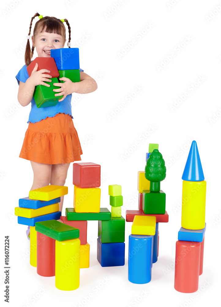 Happy child builds a castle out of blocks Happy child builds a castle out of blocks