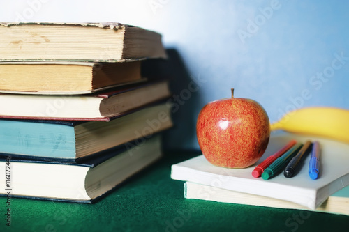 education concept books stack, apple and pen