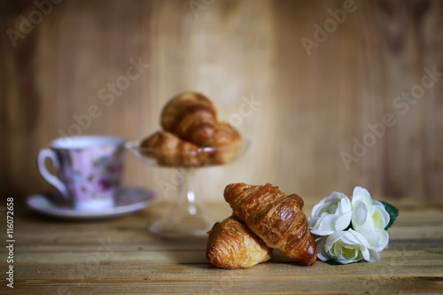 cup croissant breakfast wooden background