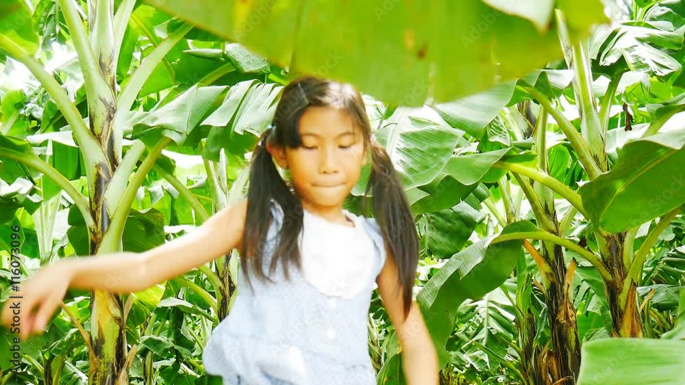 Happy children running through bananas on plantation Happy children running through bananas on plantation