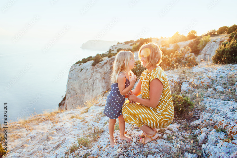 Mom playing with child in sunlight Mom playing with child in sunlight