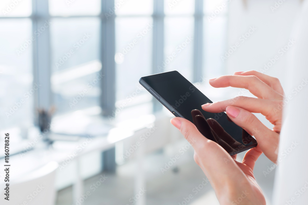 Close-up side view picture of female hands holding smartphone, using apps and wi-fi internet, reading messages. Close-up side view picture of female hands holding smartphone, using apps and wi-fi internet, reading messages.