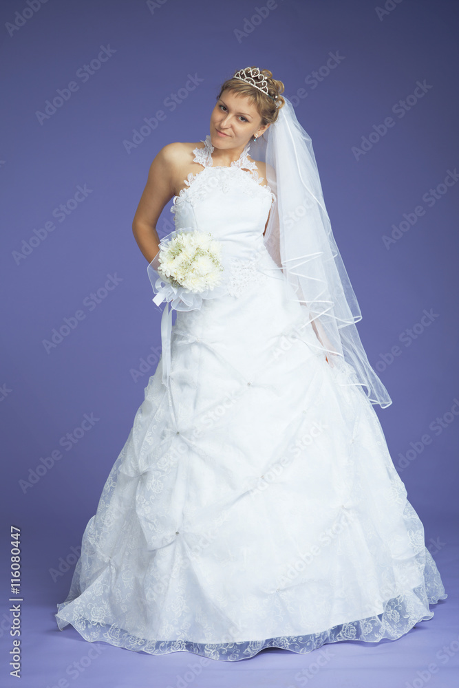 Beautiful bride poses on violet background Beautiful bride poses on violet background