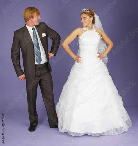 Funny Newlyweds standing on blue