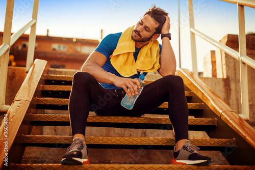 Fotografie Young athletic man after training.