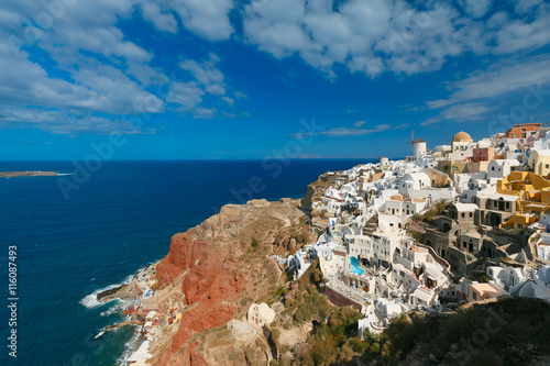 Picturesque view of windmills and white houses in Oia or Ia on the island Santorini, Greece