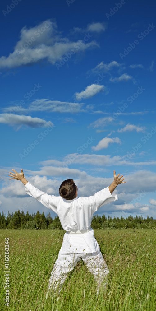 Person has lifted hands to blue sky - happiness Person has lifted hands to blue sky - happiness