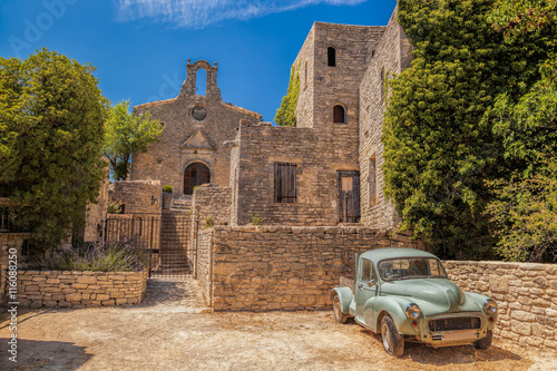 Village of Saignon with old car against church in the Luberon, Provence, France