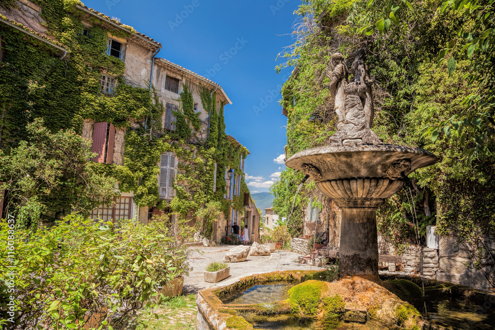 Village of Saignon with old square with fountain in the Luberon park, Provence, France