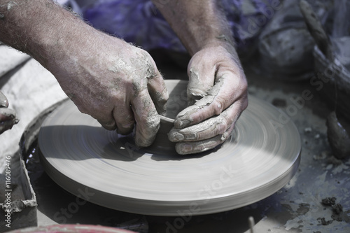 Artisan hands making clay pot