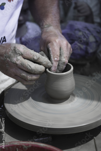 Artisan hands making clay pot