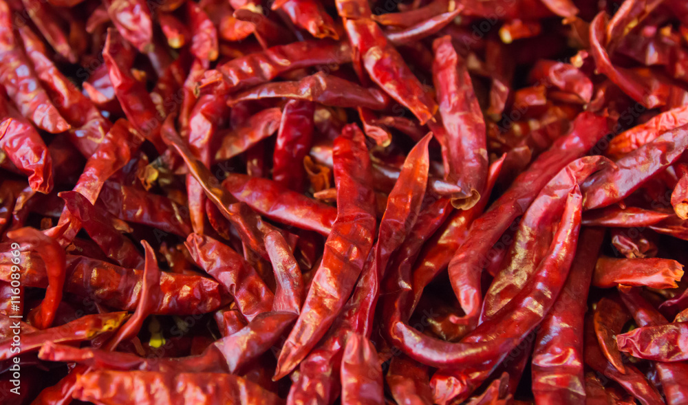 Dried chili peppers background. Many red hot pigments chile wallpaper, the combined or pile. Thai food seasoning. Close up and macro. Dried chili peppers background. Many red hot pigments chile wallpaper, the combined or pile. Thai food seasoning. Close up and macro.