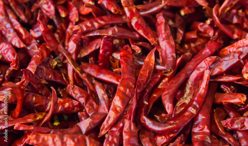 Dried chili peppers background. Many red hot pigments chile wallpaper, the combined or pile. Thai food seasoning. Close up and macro.