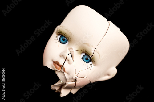 Fotobehang Broken Doll Face and Head on Black Background