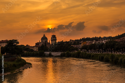 Sunset in Verona, Italy. Summer travel. River, church and cloudy