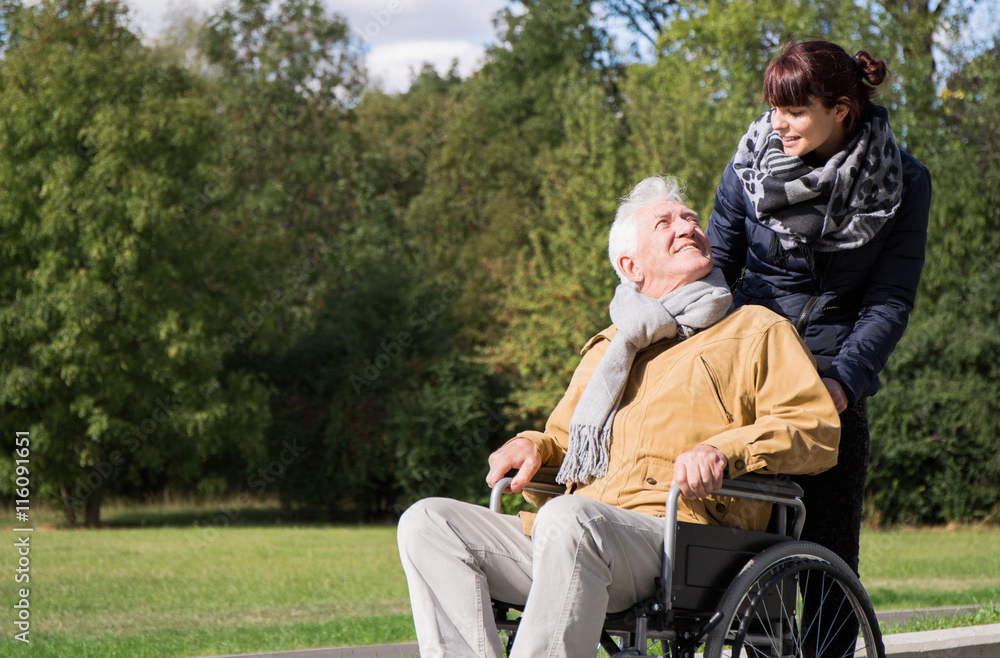 Woman supporting man on wheelchair Woman supporting man on wheelchair
