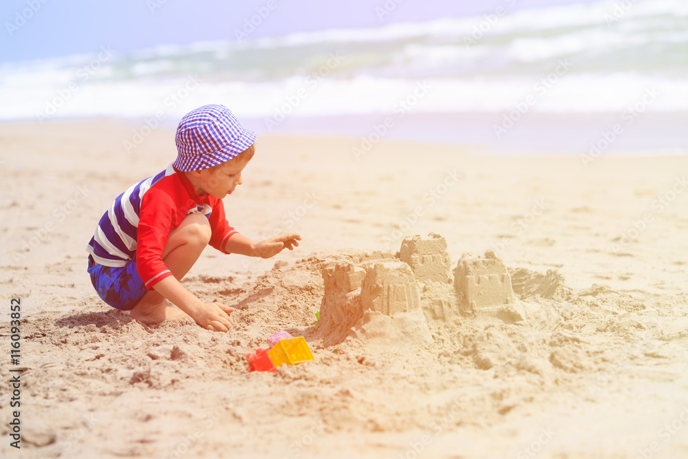 little boy play with sand on summer beach little boy play with sand on summer beach