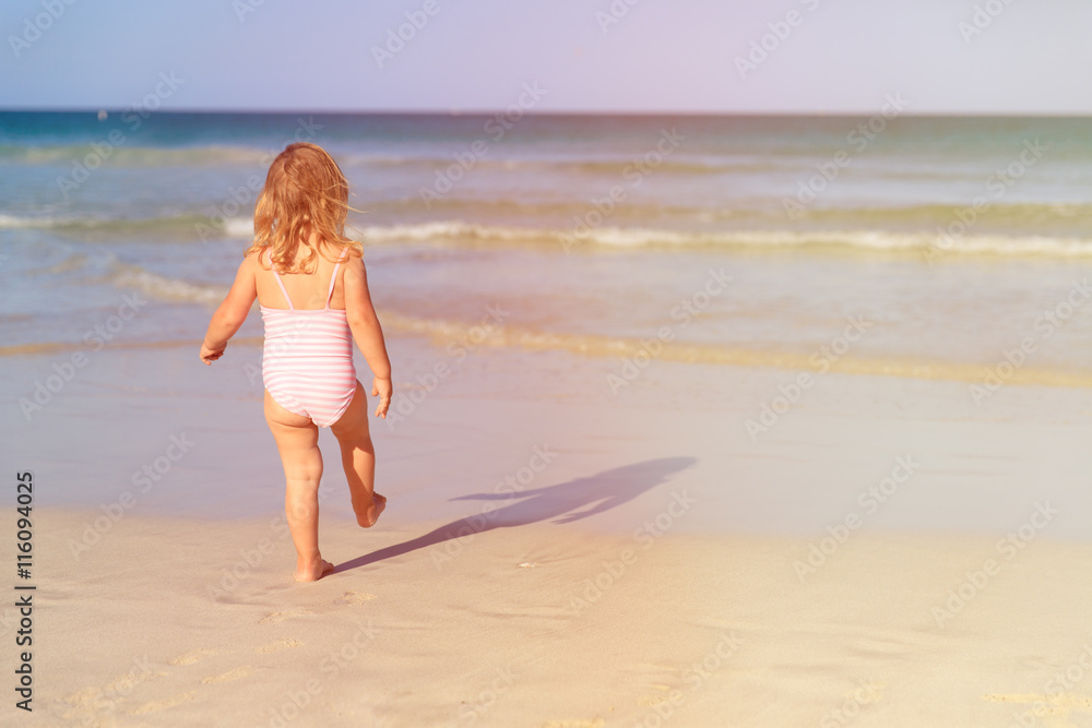 little girl going to swim at beach little girl going to swim at beach