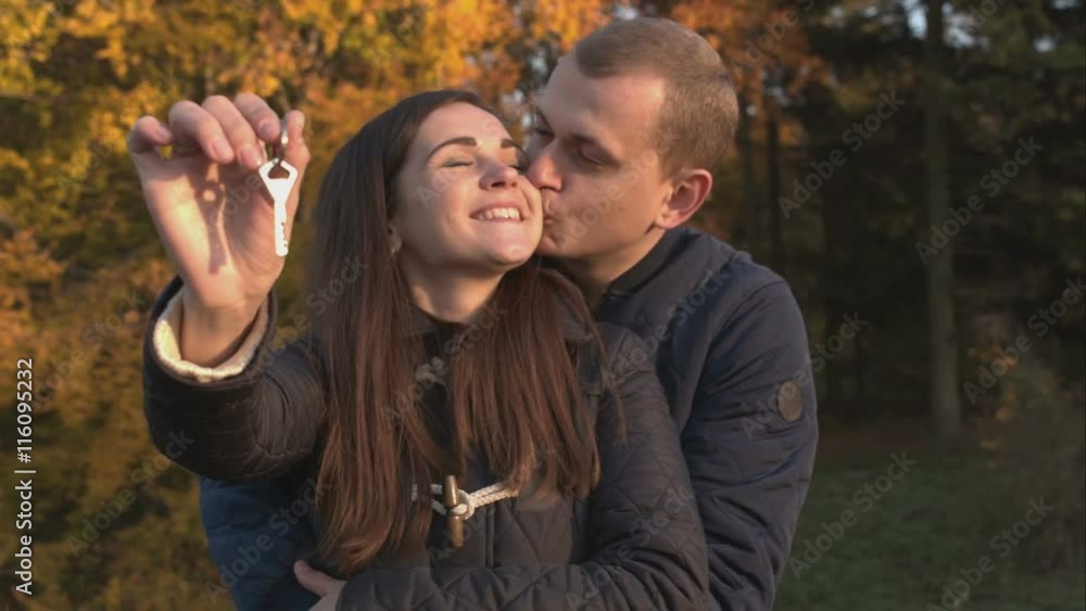 Husband kisses and hugs his wife in the park. Husband kisses and hugs his wife in the park.