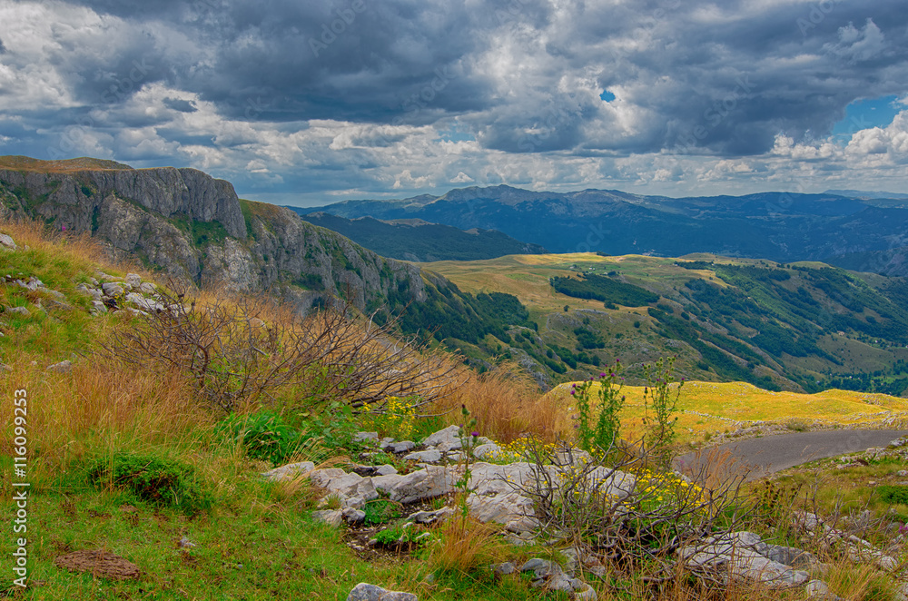Montenegro, national park Durmitor, mountains and clouds panorama. Sunlight lanscape. Nature travel background